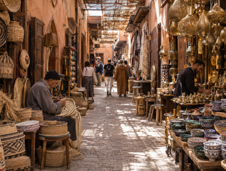 Artisan stalls with baskets, lanterns and ceramics in a Marrakech souk