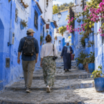 Tourists visiting Chefchaouen Morocco during pleasant spring weather.