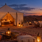 Luxury desert camp in Morocco at sunset.