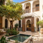 Traditional Marrakech riad courtyard with an orange tree and tiled basin