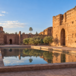 the ruins of El Badi Palace in Marrakech, with ochre walls and a reflecting pool